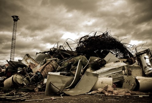 Photo showing compact skip at front of a riverside flat in Charlton
